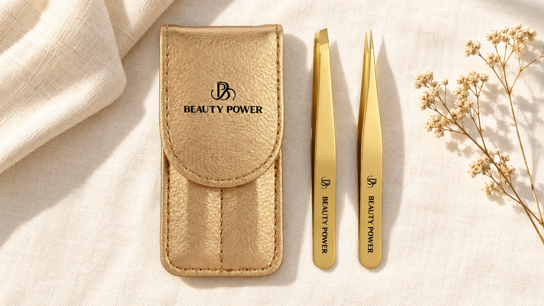 Beauty Power gold slant tip and point tip eyebrow tweezers with gold travel case on cream linen