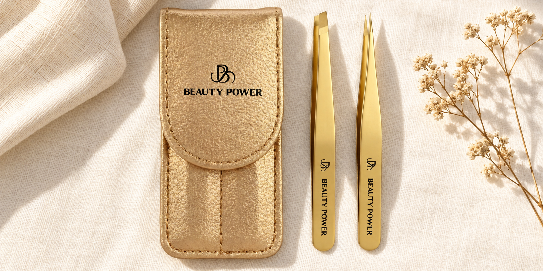 Beauty Power gold slant tip and point tip eyebrow tweezers with gold travel case on cream linen
