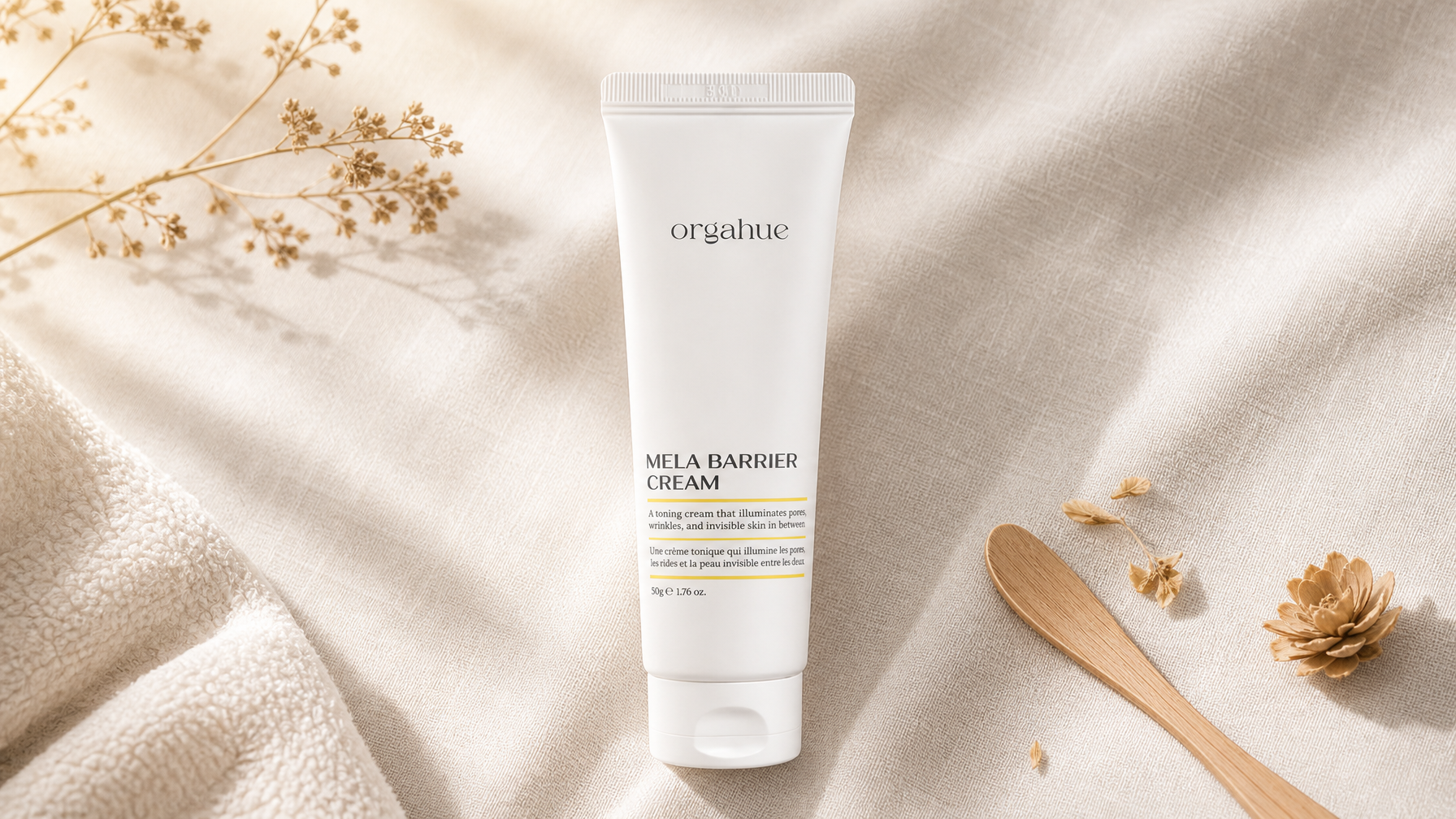 Orgahue Mela Barrier Cream tube on cream linen, Beauty Power editorial flat lay