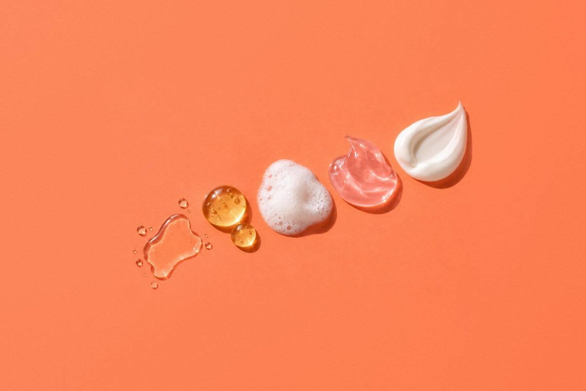 Korean skincare textures in layering order from thinnest to thickest: toner, ampoule drops, oxygen bubble foam, hydrogel jelly and cream