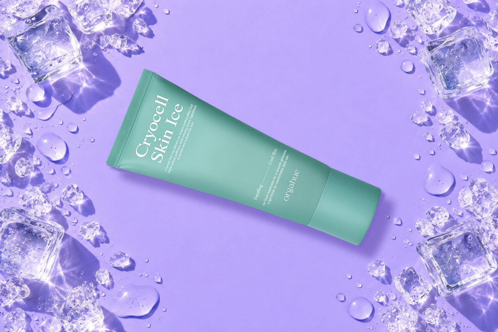Orgahue Cryocell Skin Ice cooling depuffing tube on a lilac backdrop with ice cubes and water droplets