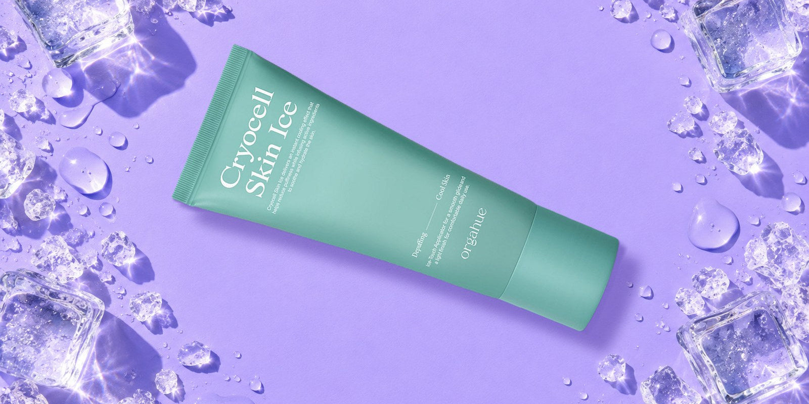 Orgahue Cryocell Skin Ice cooling depuffing tube on a lilac backdrop with ice cubes and water droplets